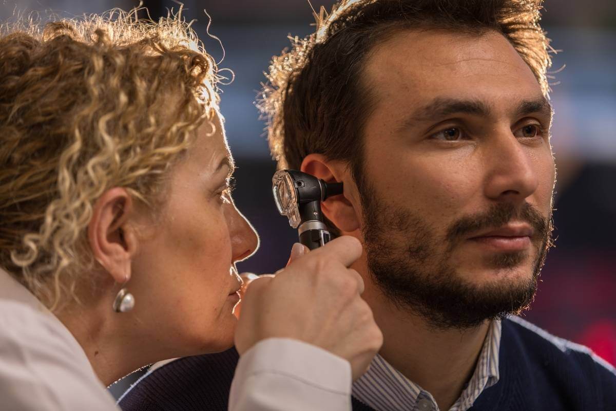 man getting his ear checked during an audiologist test