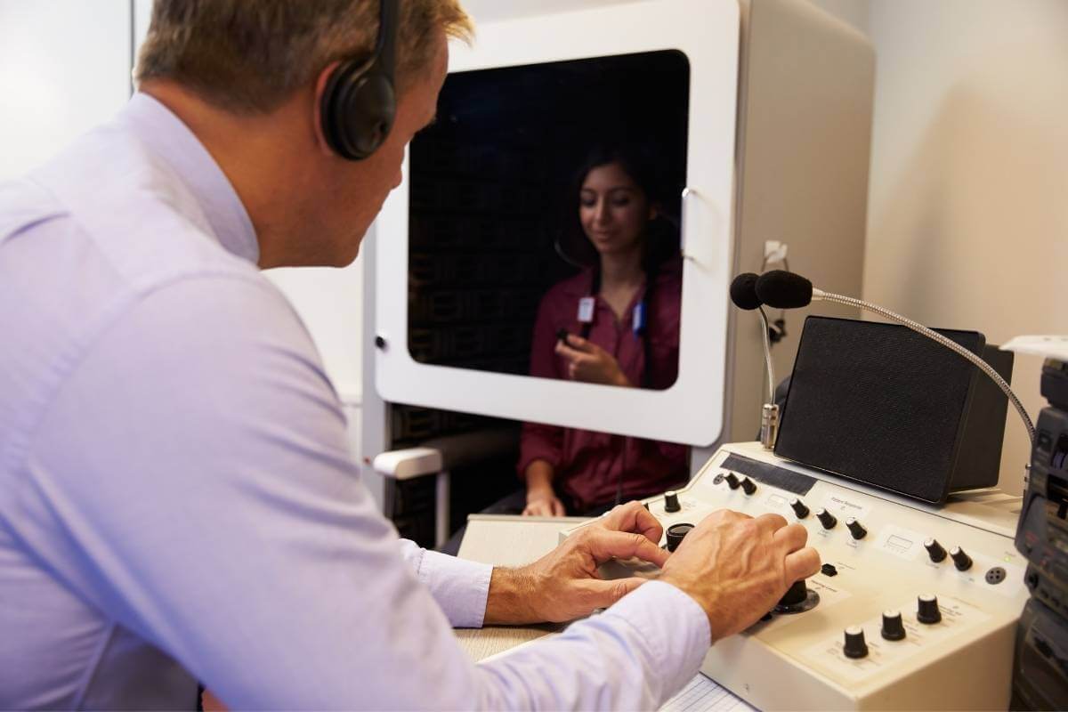 audiologist performing a word recognition test