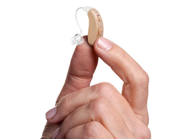 person holding a hearing aid